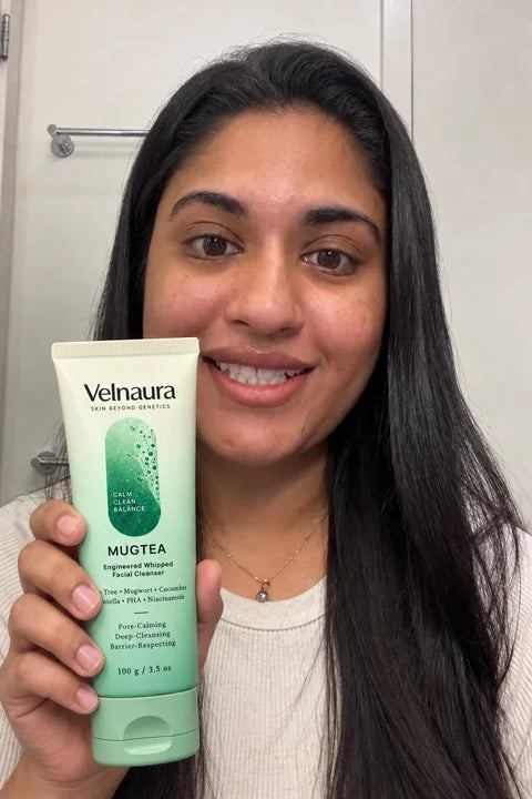 A smiling woman holds Mugtea naturally in her bathroom.